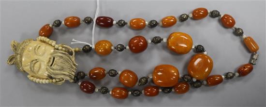 An early 20th century amber and carved ivory necklace